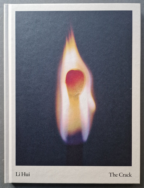 The book cover of 'The Crack' by Li Hui, featuring a striking photograph of a burning match on a dark charcoal background, with the author and title printed in black at the bottom.