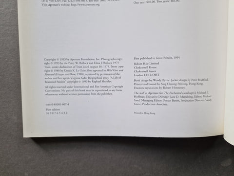 A photographed book page showing printed copyright and publication details on a dark fabric surface.