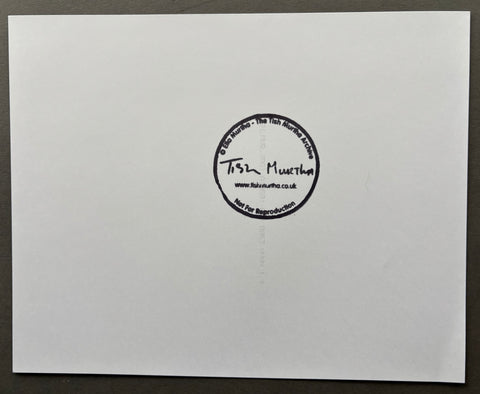 White card with a black circular stamp on a gray background