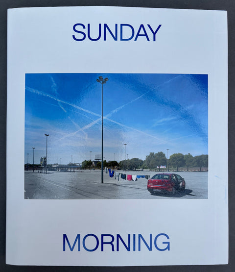 Book titled 'Sunday Morning' by Txema Salvans with a white cover featuring the image of a car park.