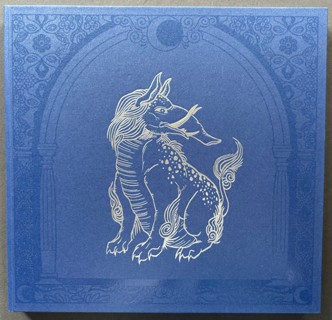Blue book with a unicorn illustration on grey background.
