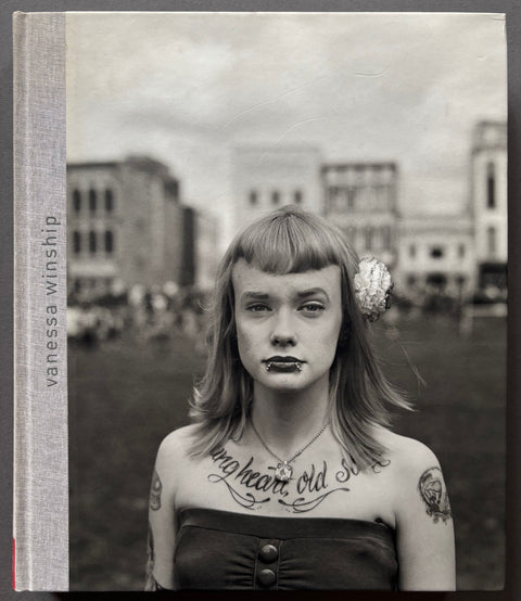 Book titled 'Vanessa Winship' with a grey cover featuring the photograph of a woman looking into the camera lens.