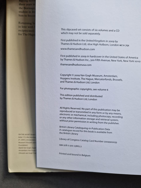 A close-up of a printed book or publication cover/back cover showing publication details, publisher text, and copyright information on a dark surface.
