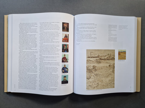 An open book spread showing printed text, small portrait photos, and a large sepia-toned historical illustration on white pages, photographed from above on a dark gray surface.