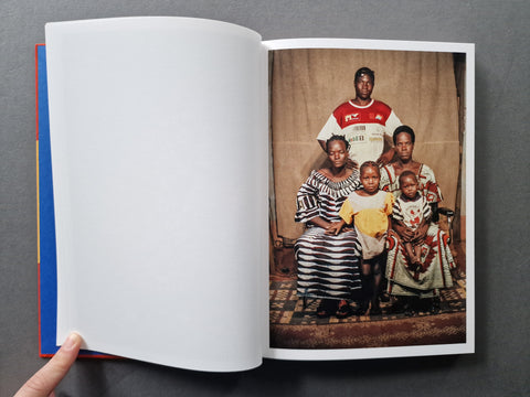 An open book spread with a blank left page and a portrait of a black faily on the right