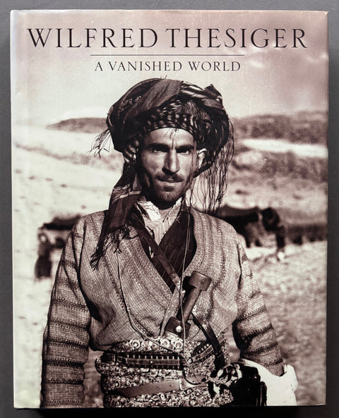 Book titled 'A Vanished World' by Wilfred Thesiger with a cover featuring the image of a Bedouin man.