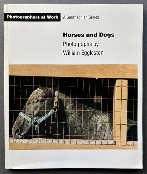 Book titled 'Horses and Dogs: Photographs by William Eggleston with a white cover featuring the image of a black horse.