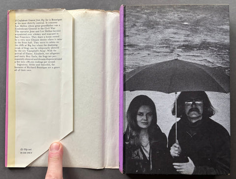 An open vintage book or magazine laid flat on a dark surface. The left page is blank with printed text at the top and a small price mark at the bottom left.