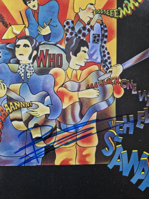 A close-up of the printed artwork of the 1966 UK LP Record A Quick One by The Who with Pete Townshend's signature in blue ink.