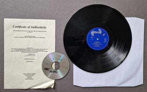 A vinyl record and CD set for The Who's album 'A Quick One' laid out on a gray surface, including the black LP, blue label, CD, Certificate of Authenticity, and paper sleeve.