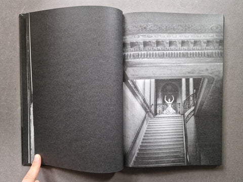 Spread of a book showing a black and white portrait of a woman who appears to be dancing on top of some stairs