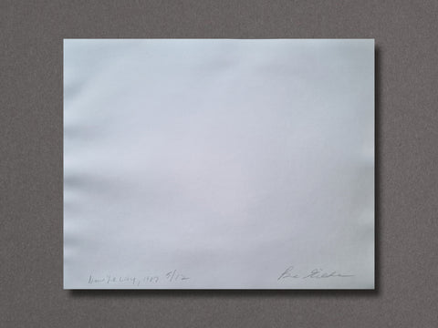 A back of an art print with handwritten signature and date markings, placed on a textured dark gray background.