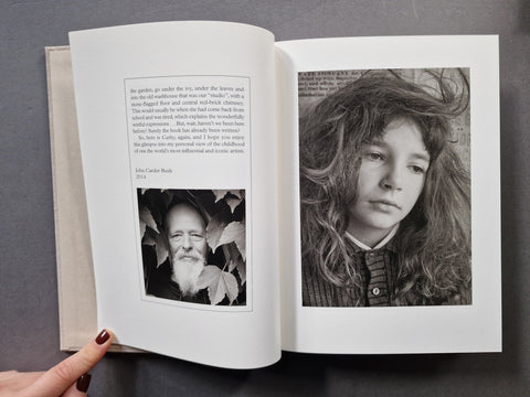An open book, showing two printed pages with text and black-and-white portraits.
