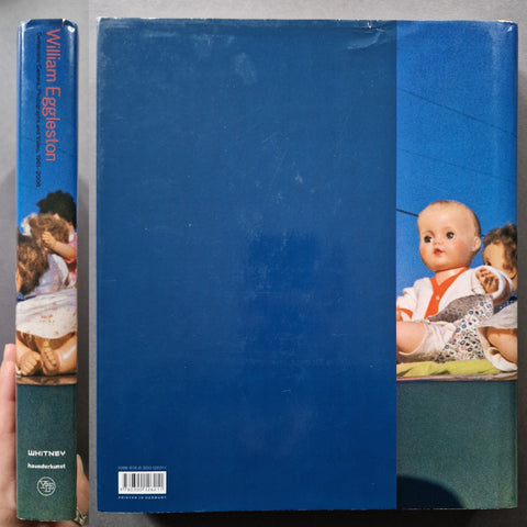 The spine and back cover of Democratic Camera Photographs and Video 1961-2008 by William Eggleston in blue
