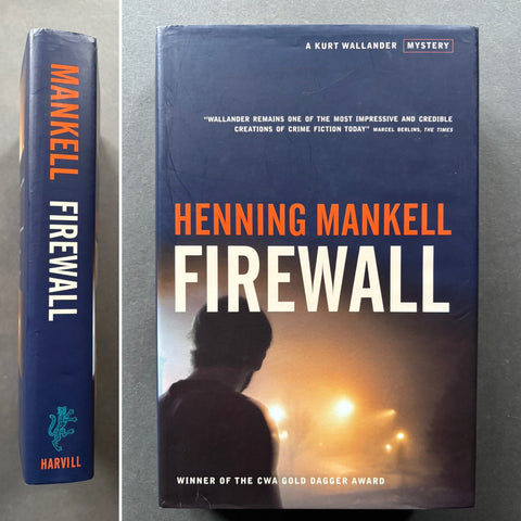 A hardcover book titled 'Firewall' by Henning Mankell, featuring a silhouette of a man against a illuminated cityscape background. The book appears to be in new condition and is displayed with its jacket on.