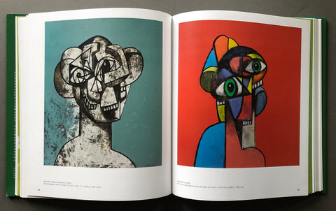 An open art book spread showing two cubist-style portrait prints side by side. The left print has a gray stone-like figure on a teal background, and the right print has a multicolored figure with green eyes on a red background.