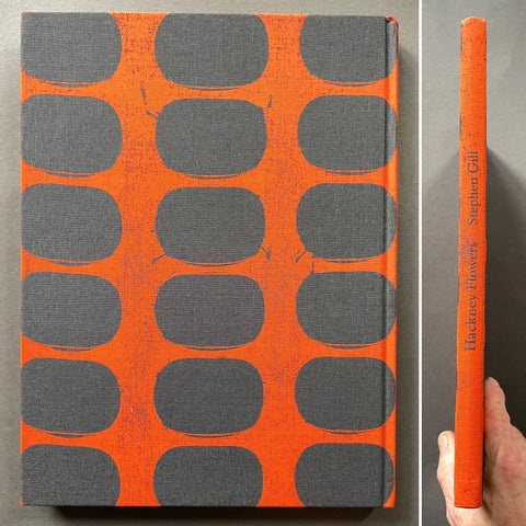 A hardcover book titled 'Hackney Flowers' by Stephen Gill, featuring a bright orange cover with a repeating pattern of dark gray rounded rectangles, shown alongside a close-up of the spine held by a hand.