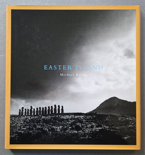 book cover of Michael Kenna's 'Easter Island', featuring a black and white landscape with the Moai statues and a mountain under a cloudy sky
