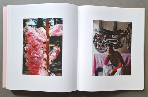 An open book, showing two printed photographs on the pages: one of pink hanging cotton candy on the left, and one of a seated person with a motorcycle in the background on the right.