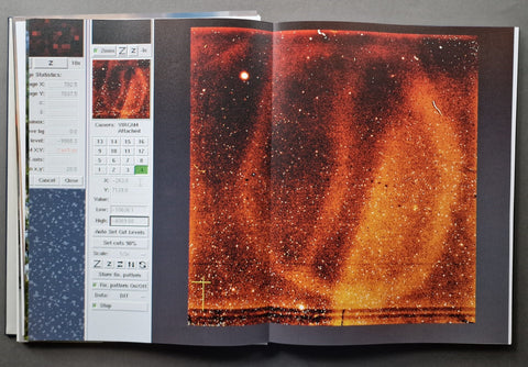 An open book, showing a large printed cosmic nebula or star field page alongside a white control panel with sliders and small preview thumbnails.