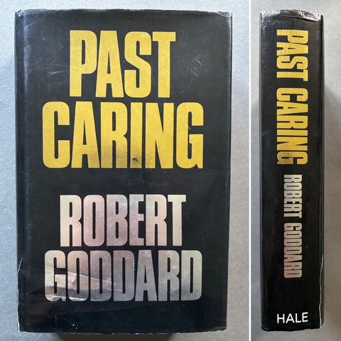 A hardcover book titled 'Past Caring' by Robert Goddard with a black cover and yellow and silver text. The book appears to be in very good condition and is shown both from the front and side to display the title and author's name.