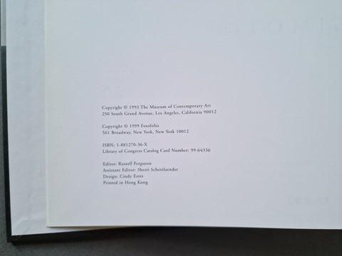 A close-up of a book's copyright page printed on white paper, showing publication details and credits, photographed against a dark surface.