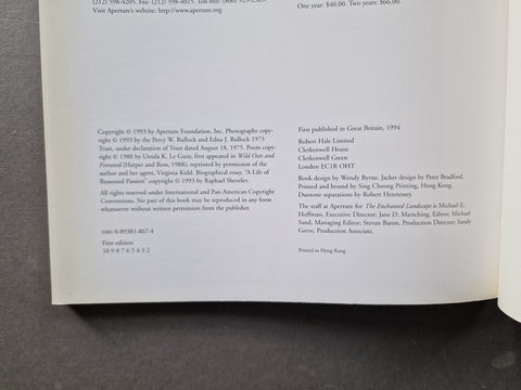 A photographed book page showing printed copyright and publication details on a dark fabric surface.