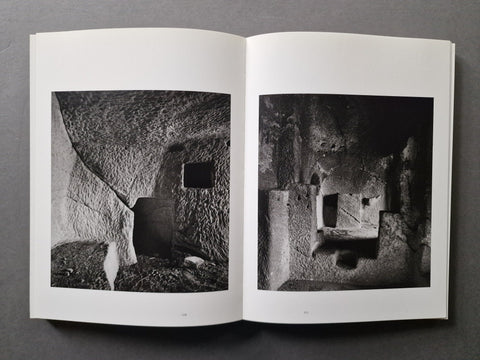 An open book, showing two black-and-white architectural photographs printed on the pages.