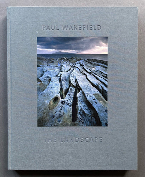 Book cover of 'The Landscape' by Paul Wakefield with a photograph of a rocky coastline on a gray background.