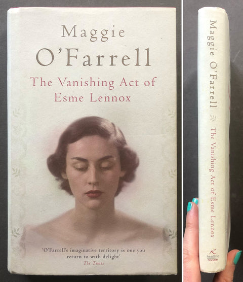 A book titled 'The Vanishing Act of Esme Lennox' by Maggie O'Farrell is shown from the front cover and spine. A hand with teal nail polish holds the spine on the right against a dark background.