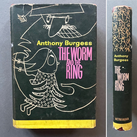 A first edition copy of 'The Worm and the Ring' by Anthony Burgess, showing signs of wear and a protective sleeve.