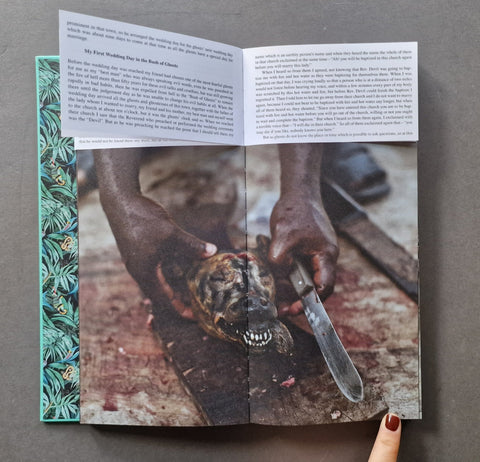 An open printed book: The left page has a teal patterned border and a large photograph showing a person holding a severed animal head with a knife.