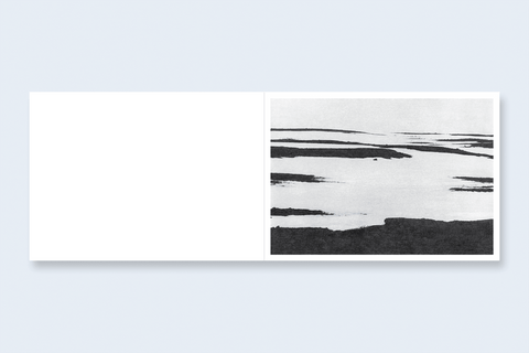 An open book spread featuring an abstract landscape on the right.