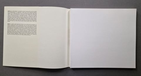 An open book, showing a single-page text layout on the left page and a blank white page on the right.
