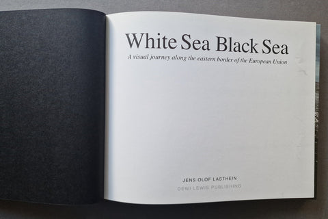 An open book. The right page contains the title 'White Sea Black Sea' with smaller subtitle text and publisher text near the bottom.