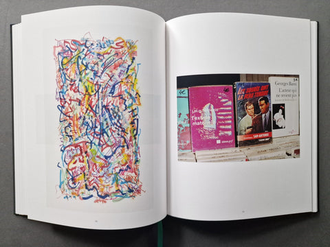 An open book: the left page has a colorful abstract scribble artwork, and the right page shows a small photo collage with vintage record covers.