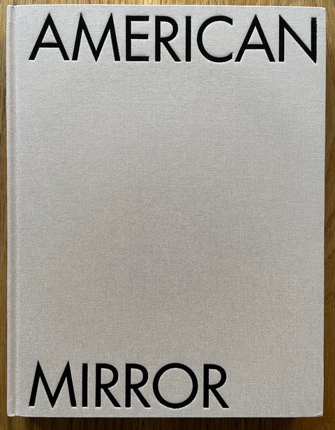 The photography book cover of American Mirror by Philip Montgomery. In hardcover beige.