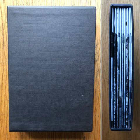 The photography book cover of Eight Stories + One LTD ed box set. Hardcover black slipcase with eight paperback books. Signed.