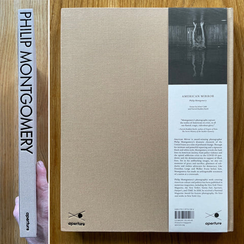 The photography book cover of American Mirror by Philip Montgomery. In hardcover beige.