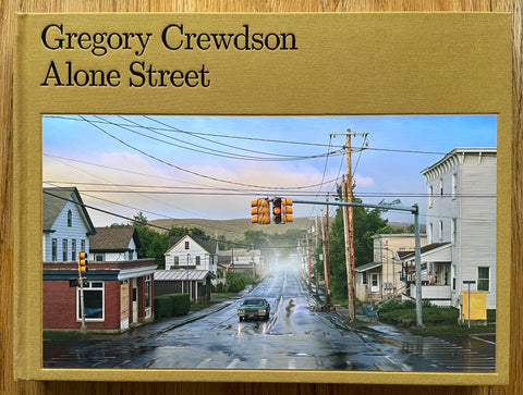 The photography book cover of Alone Street by Gregory Crewdson. In hardcover mustard.