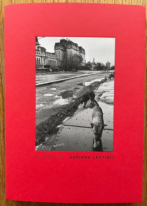 The photography book cover of Metropolis by Adriana Lestido. In softcover red sleve. Black and white paperback.