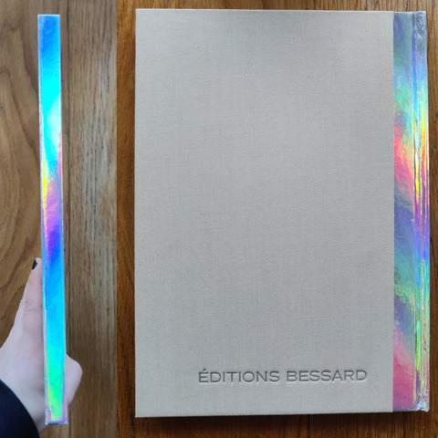 The photography book cover of Dust & Scratches by Youval Hai. In hardcover beige with chrome spine.