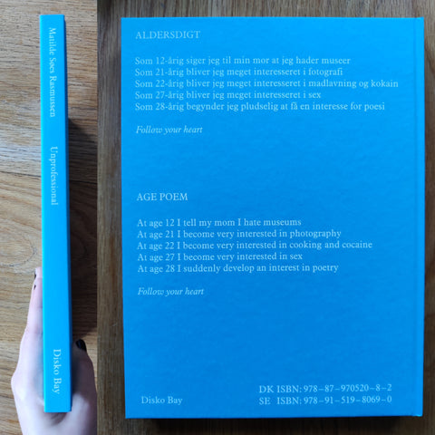 The photography book cover of Unprofessional by Matilde Søes Rasmussen. In hardcover blue.