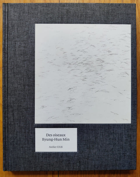 The photography book cover of Des Oiseaux by Byung-Hun Min. Hardback in dark grey.