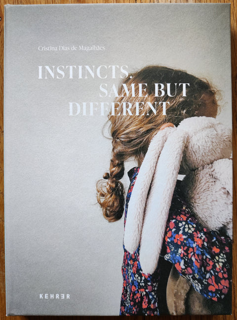 The photobook cover of Instincts. Same But Different by Cristina Dias de Magalhaes. In hardcover.