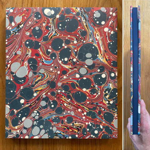 The photobook cover of the second edition of River's Dream by Curran Hatleberg. In dust jacketed hardcover with a blue page block.