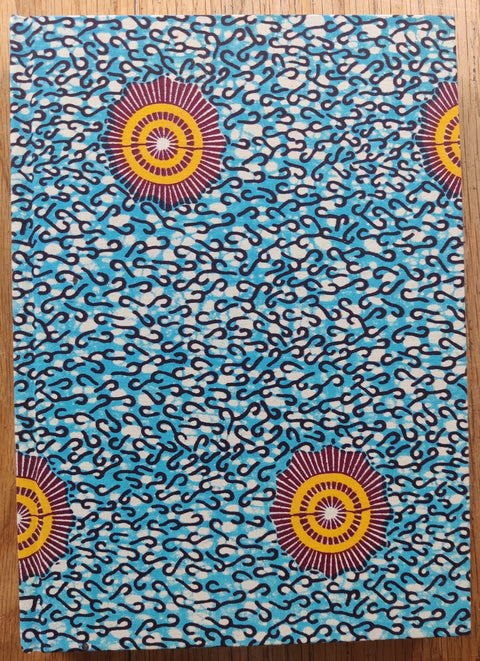 The photography book cover of Dalston Anatomy by Lorenzo Vitturi. Hardback with blue patterned cover and red/orange circles. Signed.