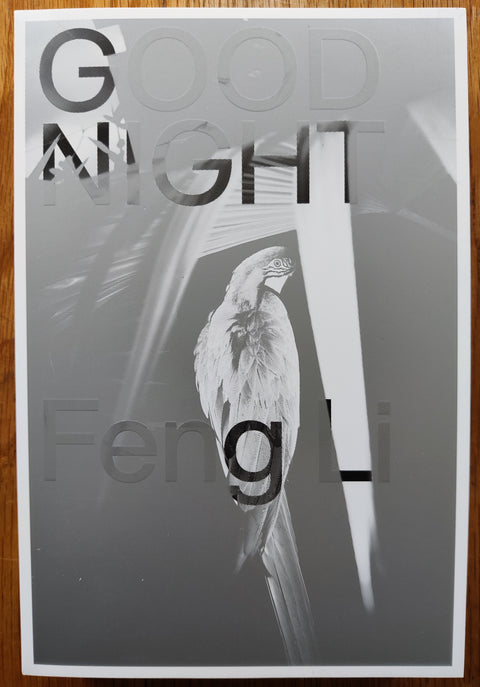 The photgraphy book cover of Good Night by Feng Li. In softcover white and grey with a parrot. Signed