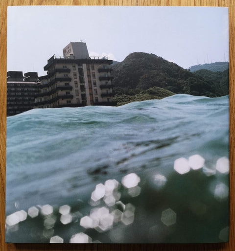 The photography book cover of Half awake and half asleep in water by Asako Narahashi. Hardback with image taken from the water.