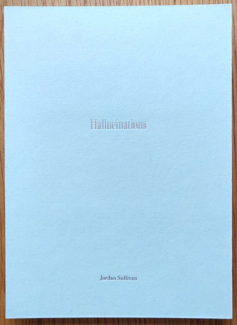 The photography book cover of Hallucinations by Jordan Sullivan. Paperback in white.
